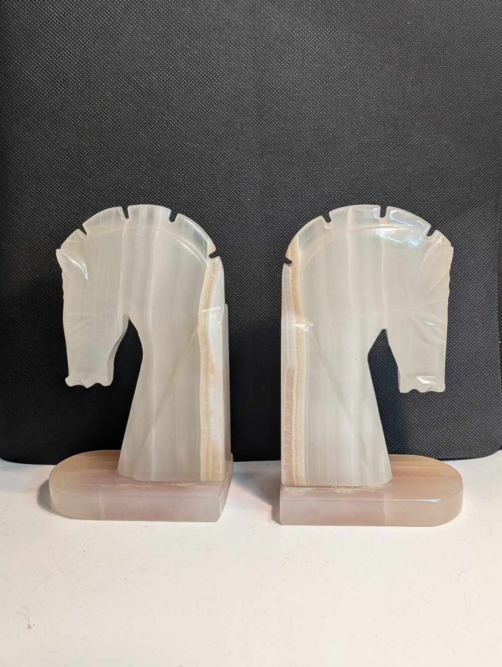 A pair of vintage hand-carved white onyx or alabaster horse head Bookends